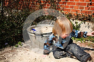 Young boy playing in sandbox