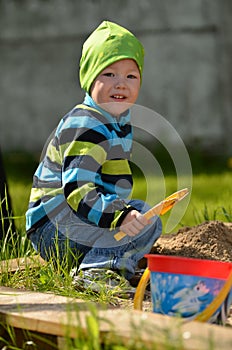 Young boy playing in the sandbox