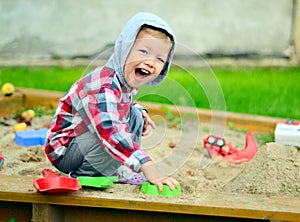 Young boy playing in the sandbox