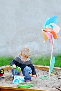 Young boy playing in the sandbox