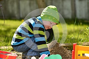 Young boy playing in the sandbox