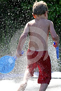 Young boy playing in shower