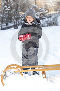 Young boy is playing in snow