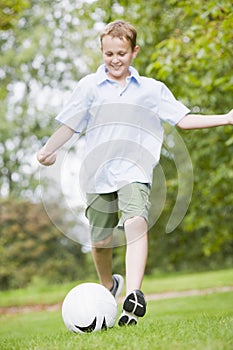 Young boy playing soccer