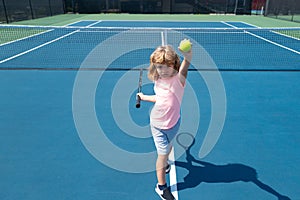 Young boy playing tennis. Kid hitting forehand in tennis.