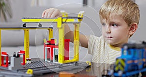 Young Boy Playing with Toy Crane