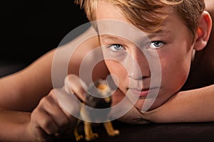 Young boy playing with a toy lion