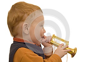 Young boy playing toy trumpet