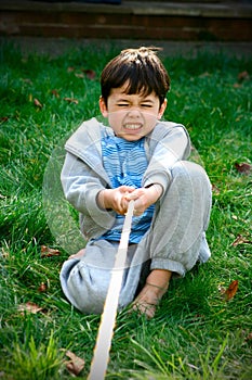 Young boy playing tug-of-war