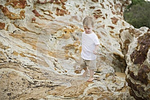 Young boy playing and walking on rocks