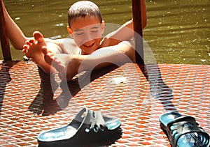 A young boy is playing in the water