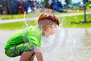 Young boy playing in water