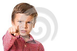 Young boy pointing with finger towards you, focus on finger