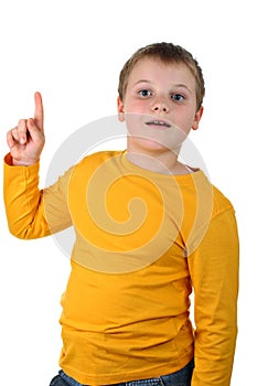 Young boy points his finger up isolated on white