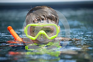 Young Boy in a Pool with a Snorkel Mask