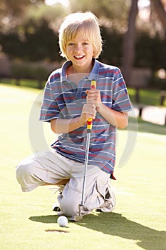 Young Boy Practising Golf