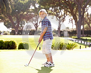 Young Boy Practising Golf