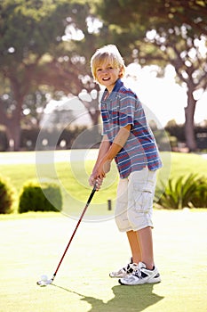 Young Boy Practising Golf