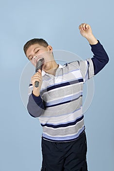 Young boy pretending rock star photo