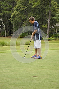 Young boy putting