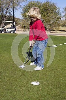 Young Boy Putting