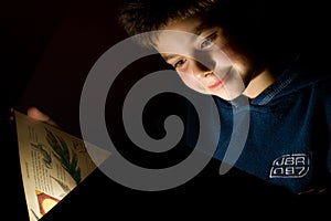 Young boy reading book