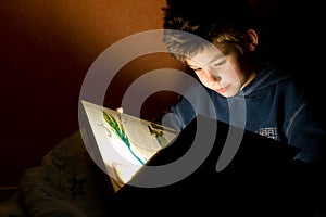 Young boy reading book