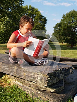 Young boy reading a book