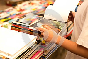 Young boy reading a book in a bookstore