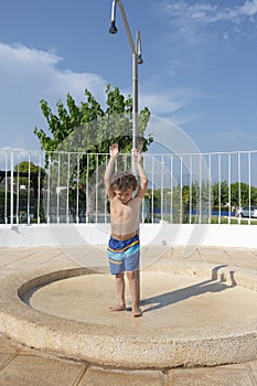 Young Boy Ready to Shower Poolside