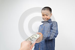 Young boy receive american bank note from hand