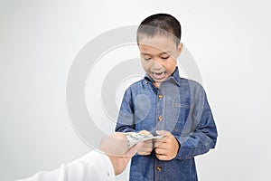 Young boy receive american bank note from hand