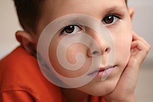 Young boy relaxed smiling with hands on chin