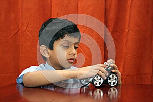 Young boy repairing toy car