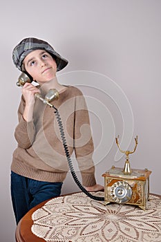 Young boy on the retro telephone