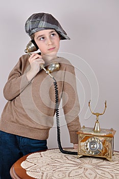 Young boy on the retro telephone