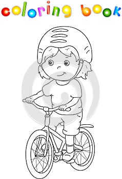 Young boy riding a bicycle in helmet
