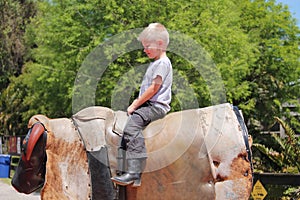 Young Boy Riding Mechanical Bull