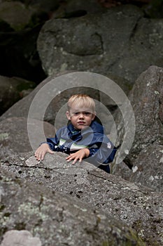 Young boy rock climbing