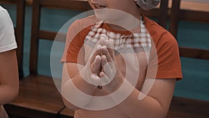 Young boy rubbing hands with flour before rolling dough on cooking class. Little boy cook preparing dough on culinary