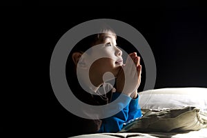 Young boy's bedtime prayer.