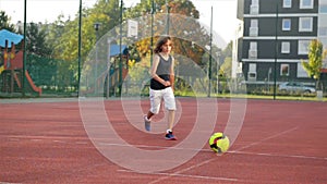 A young boy scores a goal during a penalty shoot out. slow motion. Outdoors. Sport it`s source to health life.