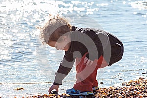 Young Boy Searching for Shells at Beach