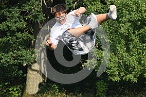 Young Boy, with shorts, and Shirt falling down, from high tree