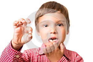 Young boy showing his first lost milk-tooth