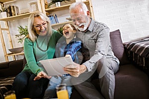 Boy showing his older grandparents new technology