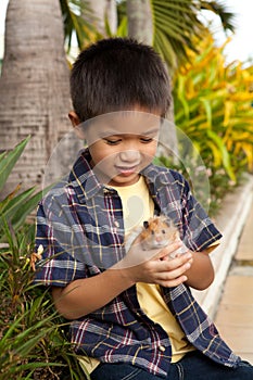 Young boy showing off his pet hamster