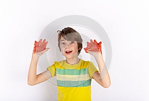 Young boy showing red slime on his hands