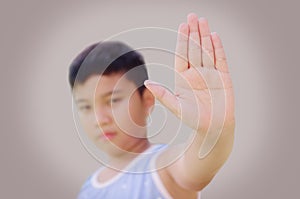 Young boy showing Stop hand signal