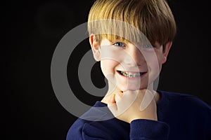 A Young Boy Shows off his Green Braces